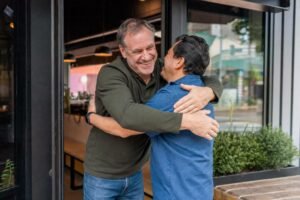Two old male friends embracing